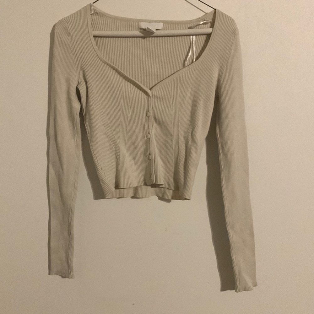 Cream button up low cut shirt.
